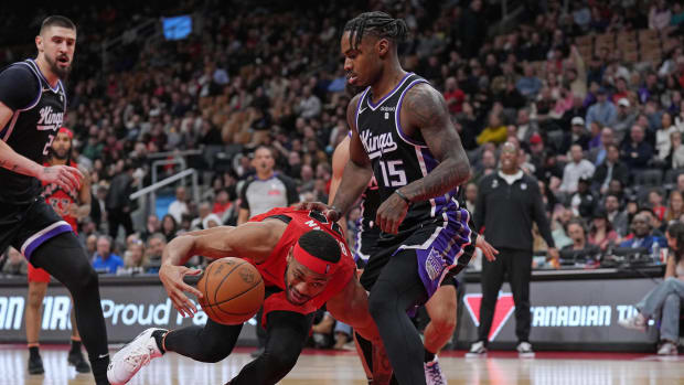 Mar 20, 2024; Toronto, Ontario, CAN; Toronto Raptors forward Bruce Brown (11) controls the ball as Sacramento Kings guard Davion Mitchell (15) tries to defend during the fourth quarter at Scotiabank Arena. Mandatory Credit: Nick Turchiaro-USA TODAY Sports  
